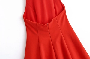 Detail view of red dress back showing deep U-shaped cut-out and invisible zipper