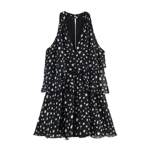 Close-up of tiered ruffle layers on a black polka dot sleeveless halter neck dress