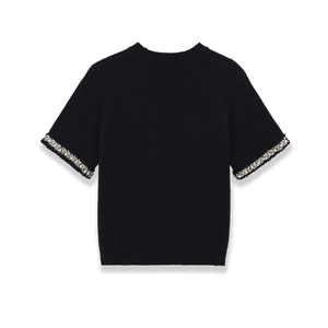Top in maglia nera a maniche corte con perle finte sui polsini vista posteriore