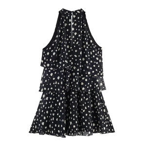 Detailed view of white polka dot tiered mini dress with halter neck and ruffled layers