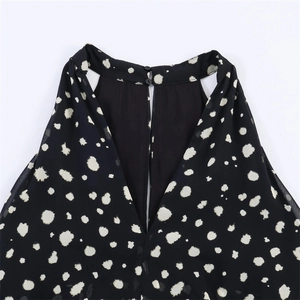 Detail of polka dot halter neck top with chiffon texture and back button closure