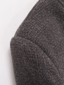 Close-up of high-quality dark grey woolen blazer fabric with durable shoulder stitching