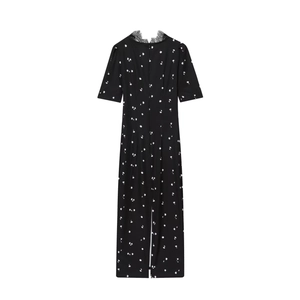 Close-up of elegant V-neckline with black lace trim and white floral pattern detail