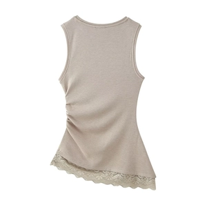 Detailed close-up of beige sleeveless knit top with side ruching and lace trim hem