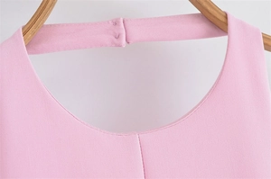 Close-up of pink sleeveless dress neckline with halter back strap and secure hook closure