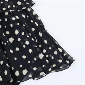 Detailed view of layered ruffles and polka dot fabric on a spring fashion dress