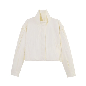 Close-up of cream zip-up high-neck jacket featuring size S label and fabric texture