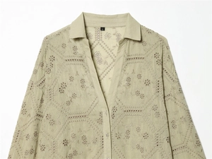 Detail of light green shirt with eyelet floral embroidery and lace stitching textures
