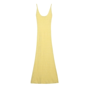 Detail of light yellow knit maxi dress showing intricate geometric crochet texture