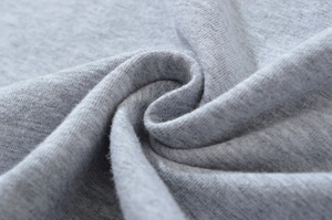 Close-up of heather grey knitted fabric showing soft texture and premium cotton blend detail