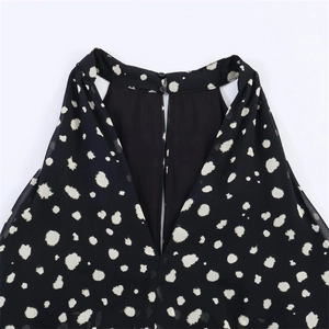 Chic black halter neck sleeveless top with white polka dots and delicate back buttons