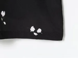Detail of floral print fabric with fine twill texture and smooth stitched edge finish