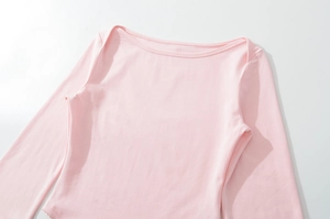 Close-up of pink long-sleeve top showing boat neck and precise stitching details
