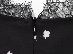 Close-up of floral dress with delicate black eyelash lace trim and invisible zipper