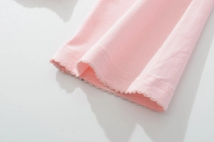 Detail of light pink ribbed cotton sleeve featuring sweet lettuce trim and double stitching