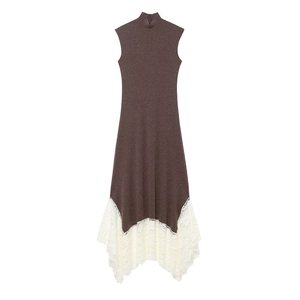 Detail of elegant brown knit dress showing asymmetric white lace hem and fishtail design
