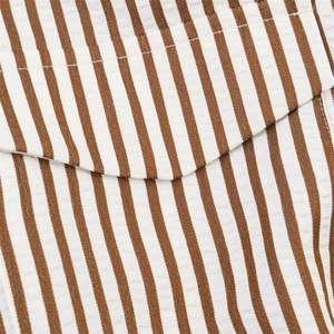 Macro shot of brown and white seersucker striped fabric with fine stitching detail