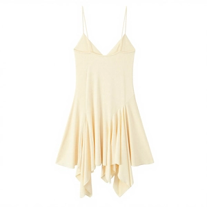 Detail of light yellow slip dress featuring asymmetric ruffled hem and thin straps