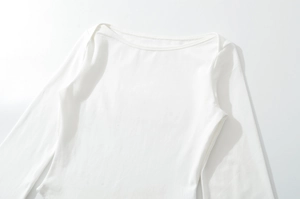Detailed close-up of white boat neck T-shirt with elastic knit fabric and slim fit design