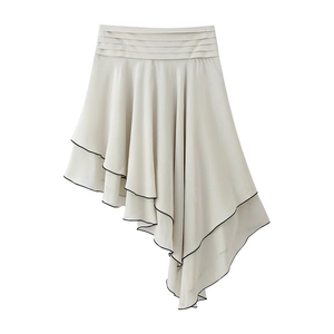 Close-up of beige tiered skirt with black contrast piping and pleated ruffle details