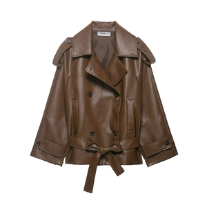 Close-up of brown faux leather cropped trench jacket with epaulettes and buckle details