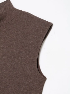 Detail of mock neck stitching and dark brown knit texture on a sleeveless dress