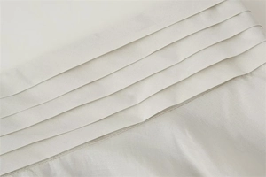 Detailed macro view of champagne satin fabric with elegant parallel pleated design