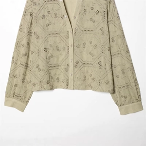 Green long sleeve shirt for women featuring detailed eyelet embroidery and a button-up V-neck
