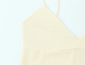 Detail of light yellow knit camisole featuring thin straps and neat V-neck stitching