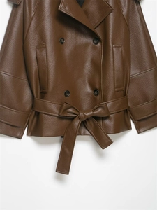 Detail of a dark brown faux leather jacket featuring a lapel collar and waist belt tie