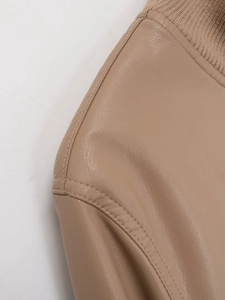 Detail view of ribbed knit collar and precise stitching on beige faux leather jacket