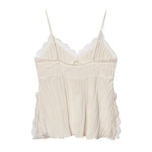 Close-up of beige pleated camisole featuring delicate white lace trim and thin straps