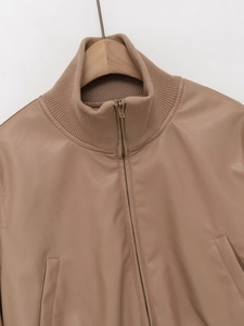 Detail of khaki faux leather bomber jacket with ribbed collar and metal zipper