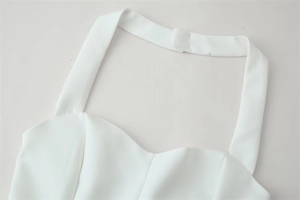 Detail of white halter neck top with sweetheart neckline and structured darts
