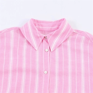 Close-up of pink and white striped shirt collar with pearl buttons and linen texture