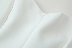 Detailed close-up showing the smooth white fabric texture and precise stitching of top
