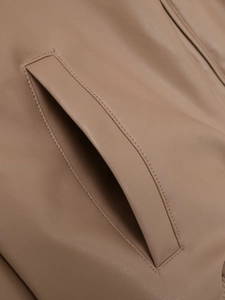 Detail of the khaki faux leather bomber jacket showing reinforced double stitching on pocket