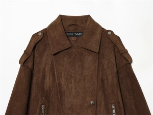 Close-up of brown faux suede biker jacket featuring shoulder straps and silver zip details