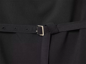 Close-up of black sleeveless top with adjustable waist belt and silver square metal buckle