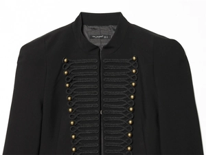 Detail of military style blazer with gold spherical buttons and black braided rope trim