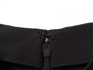 Detailed close-up of a black invisible zipper with a secure metal hook and eye fastener