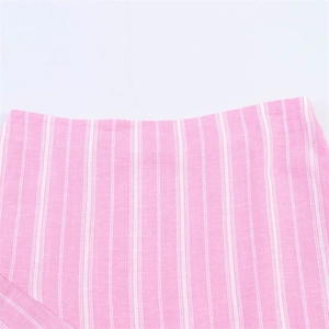 Detail of pink and white vertical striped fabric with fine woven texture for women's skirt