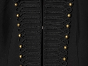 Detailed close-up of woven braided knots and antique bronze metal buttons on black blazer