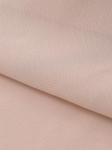 Macro detail of high-density light pink chiffon fabric with elegant drape and texture