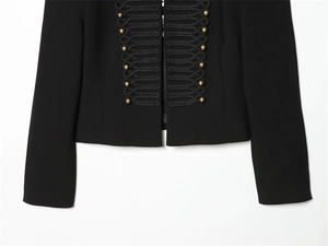 Detail of black military jacket featuring vintage gold ball buttons and braided frogging