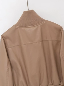 Detail of the stand-up ribbed collar and high-quality faux leather stitching on the jacket