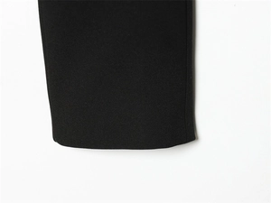 Close-up of the black blazer sleeve cuff showing premium fabric texture and seamless stitching