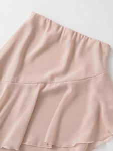 Detailed view of pale pink chiffon fabric featuring an elastic waist and ruffled hemline
