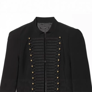 Detailed view of military style stand collar with ornate woven buttons and braided trim