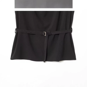 Women's chic black sleeveless top with matching belt and silver buckle close-up view